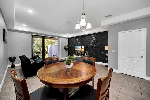 tiled dining space featuring an inviting chandelier