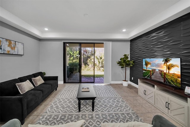 8169 Roseville Rd, Davenport, FL 33896 - living area featuring an accent wall, recessed lighting, light tile patterned floors, and a raised ceiling