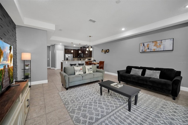 tiled living room with an inviting chandelier