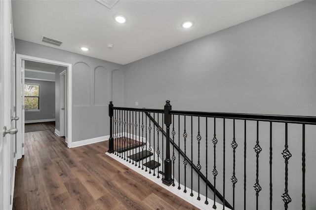 corridor with hardwood / wood-style flooring