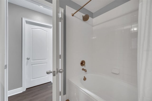 bathroom with shower / bath combo and wood-type flooring