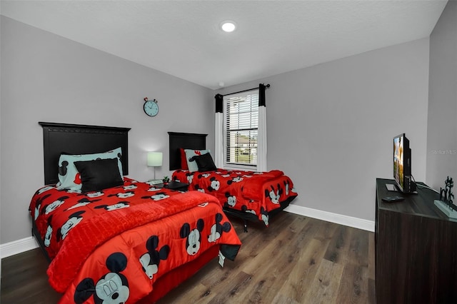 bedroom with dark hardwood / wood-style floors