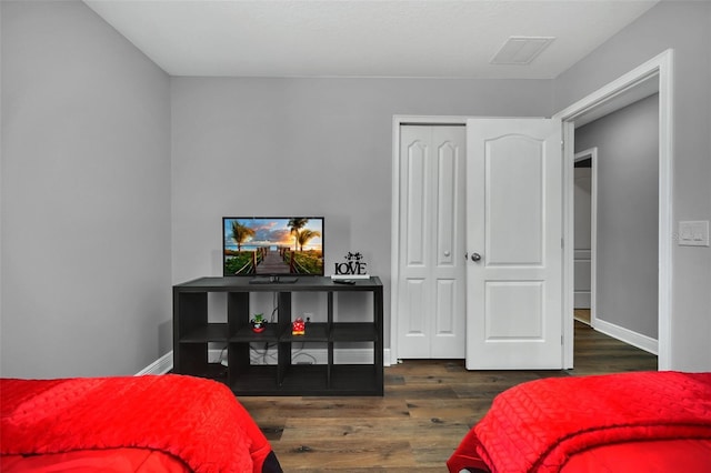 bedroom featuring dark hardwood / wood-style floors and a closet