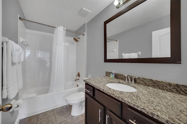 full bathroom featuring tile patterned floors, a textured ceiling, toilet, shower / tub combo with curtain, and vanity