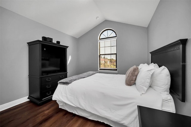 bedroom with lofted ceiling and dark wood-type flooring