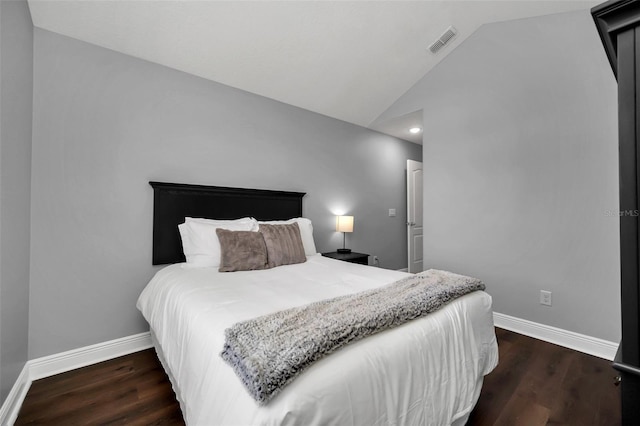 bedroom featuring dark hardwood / wood-style floors and vaulted ceiling