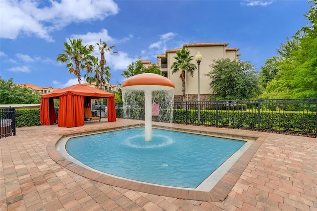 view of swimming pool featuring a gazebo and a patio area