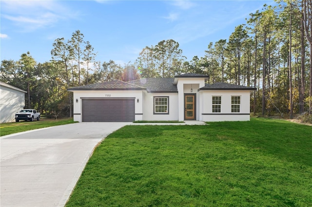 view of front facade with a garage and a front lawn