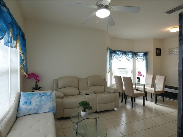 living room featuring ceiling fan and light tile patterned floors