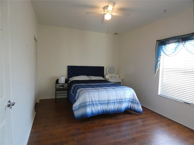 bedroom featuring ceiling fan and dark hardwood / wood-style floors