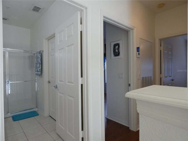 bathroom featuring tile patterned flooring and a shower with door