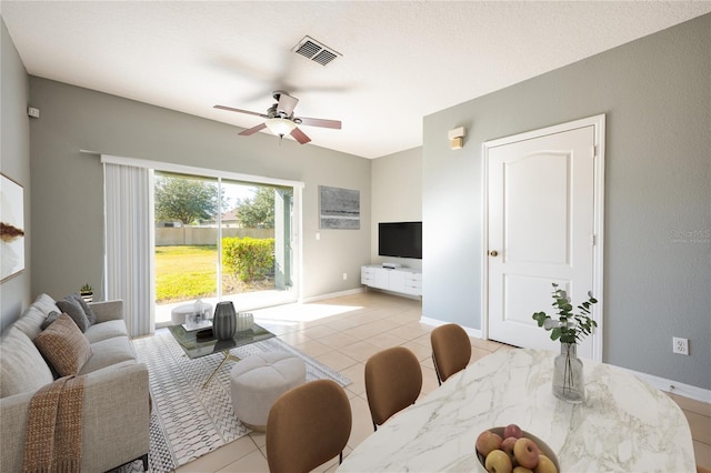 tiled living room with ceiling fan