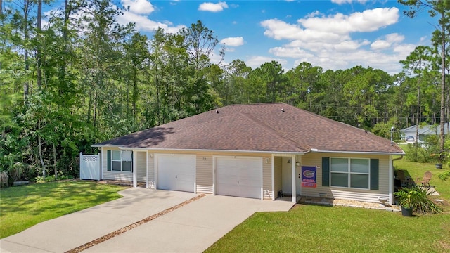 ranch-style home featuring a garage and a front lawn