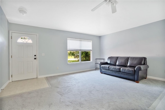 carpeted living room featuring ceiling fan