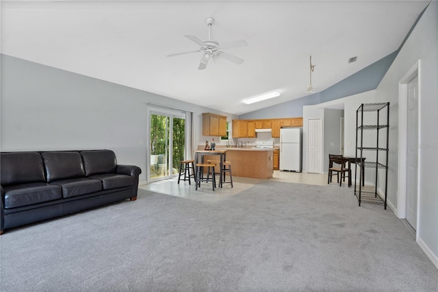 carpeted living room featuring vaulted ceiling and ceiling fan