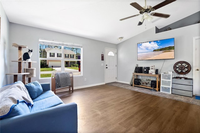 living room featuring dark hardwood / wood-style floors, vaulted ceiling, and ceiling fan