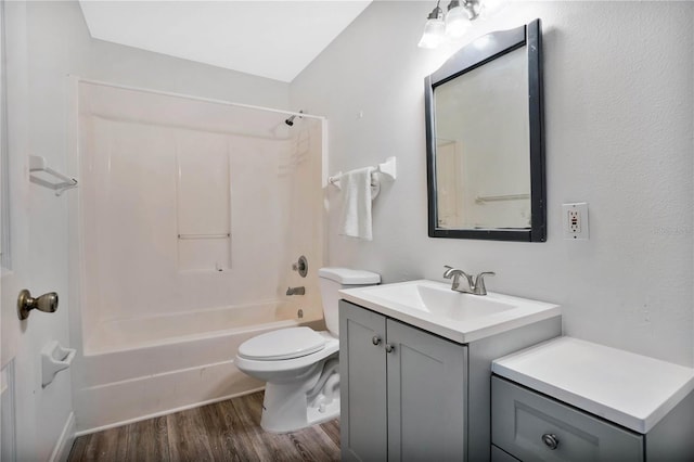 full bathroom featuring hardwood / wood-style flooring, vanity, toilet, and shower / washtub combination