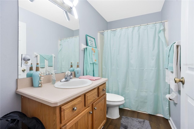 bathroom featuring wood-type flooring, vanity, and toilet