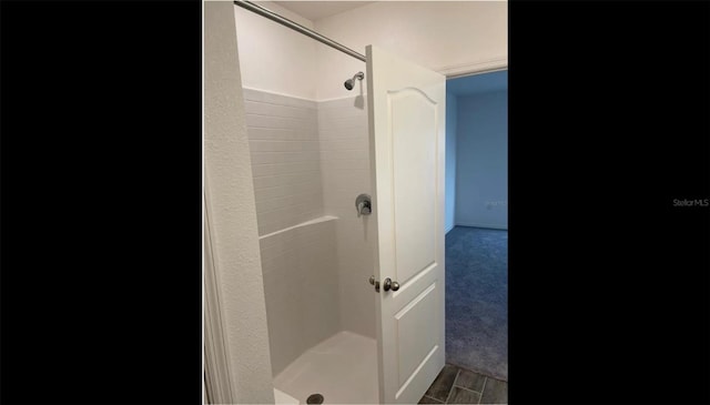 bathroom with wood-type flooring and walk in shower