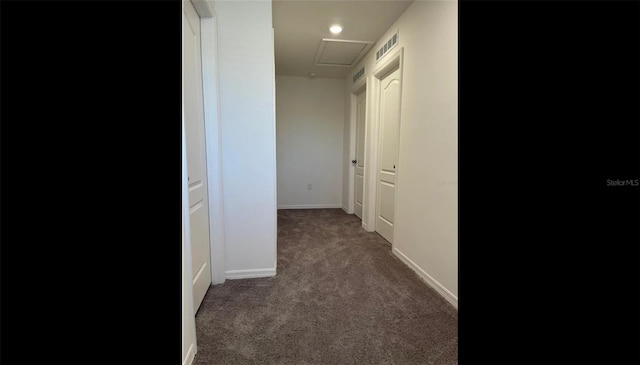 corridor with dark colored carpet