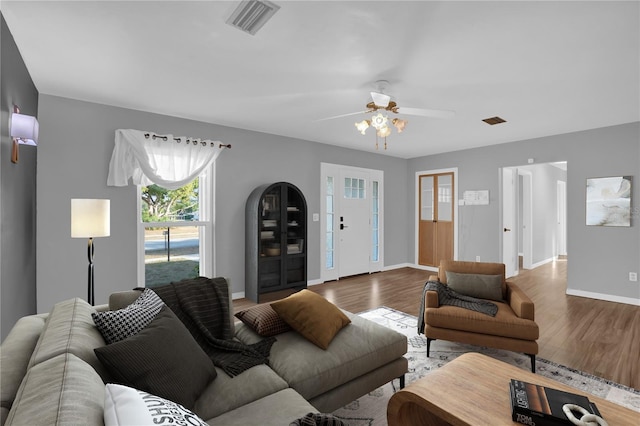 living room featuring hardwood / wood-style flooring and ceiling fan