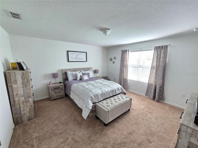 bedroom featuring carpet flooring and a textured ceiling