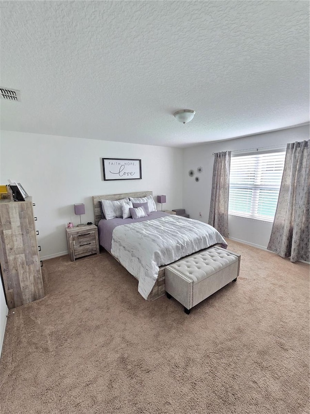 bedroom featuring carpet floors and a textured ceiling