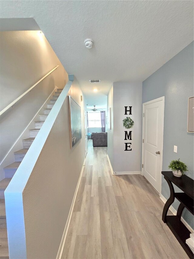 604 Madison Dr, Davenport, FL 33837 - hall with wood finished floors, stairway, and a textured ceiling