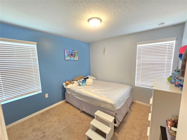 carpeted bedroom with a textured ceiling