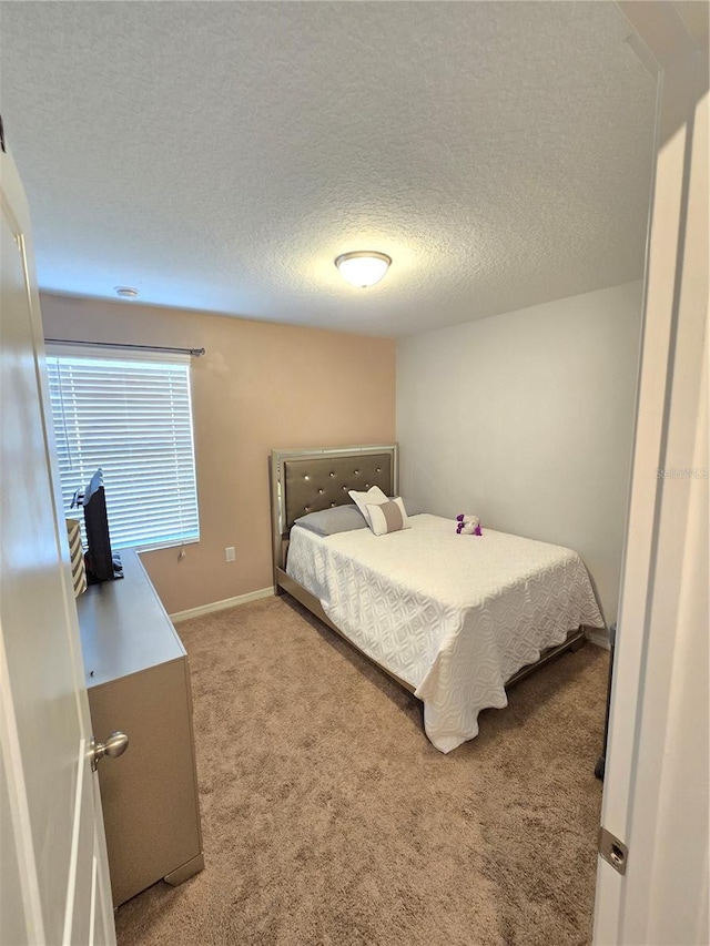 carpeted bedroom with a textured ceiling