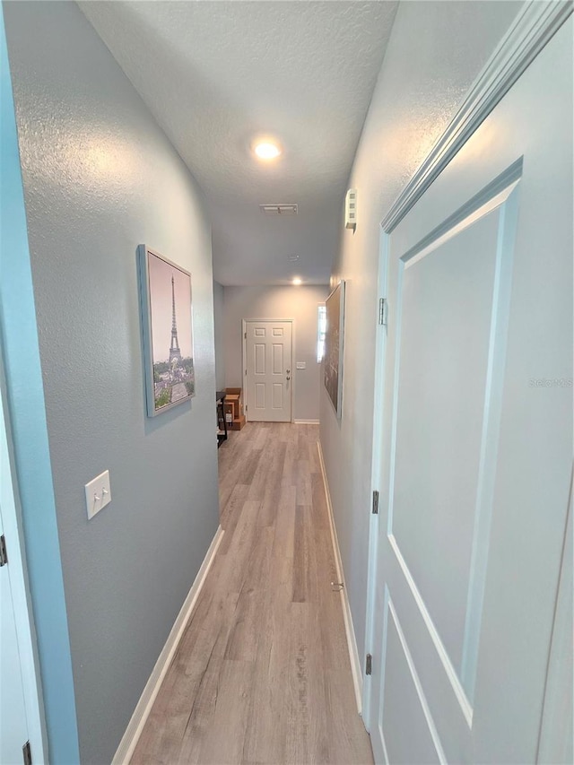 corridor with light wood-type flooring