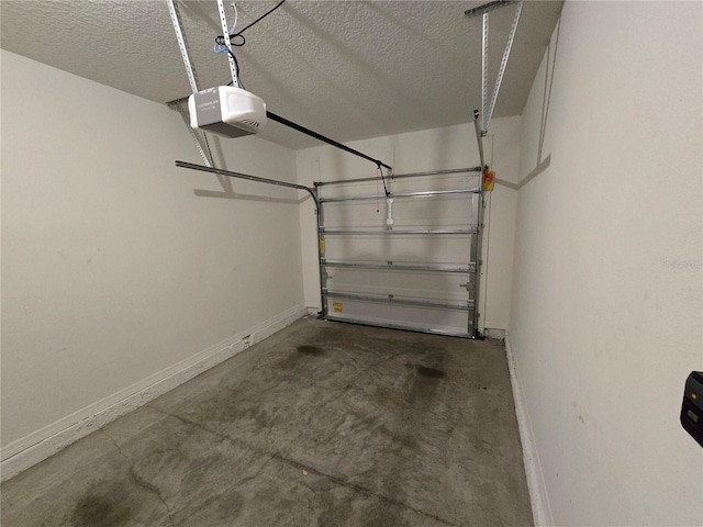 604 Madison Dr, Davenport, FL 33837 - garage featuring baseboards and a garage door opener