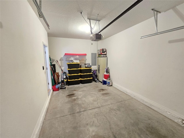 garage featuring electric panel and a garage door opener