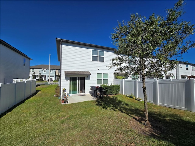 rear view of property featuring a yard