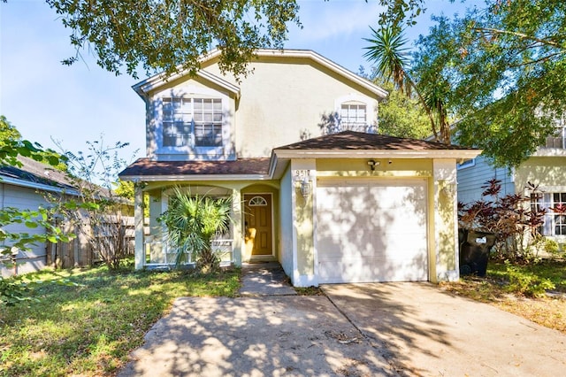 view of front of home featuring fence, stucco siding, driveway, and a garage