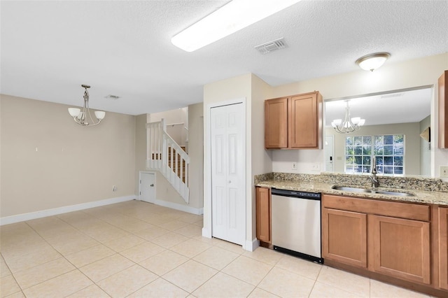 kitchen featuring a sink, stainless steel dishwasher, brown cabinetry, and a notable chandelier