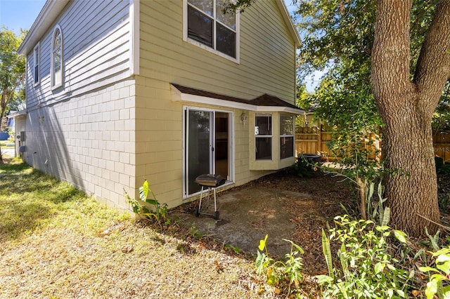 rear view of property featuring fence