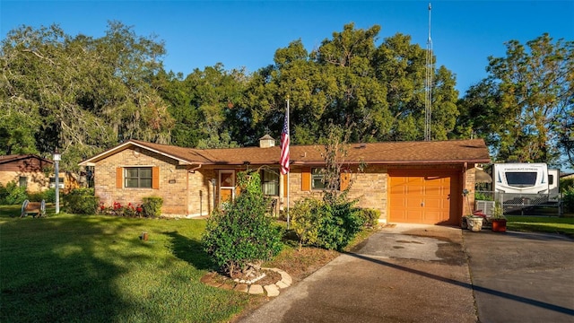 ranch-style house featuring a garage and a front lawn