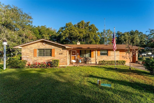 ranch-style home with a garage and a front lawn