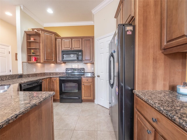 kitchen with dark stone counters, black appliances, crown molding, decorative backsplash, and light tile patterned flooring