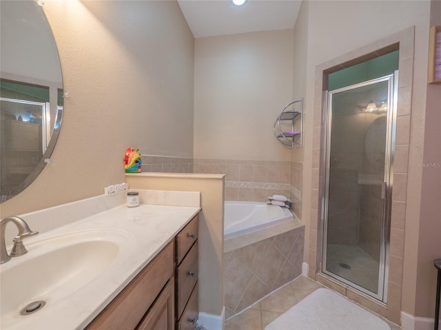 bathroom featuring tile patterned flooring, vanity, and plus walk in shower