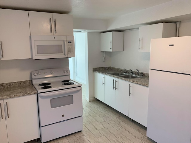 kitchen featuring white cabinets, light hardwood / wood-style floors, white appliances, and sink