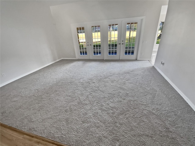 carpeted spare room with french doors