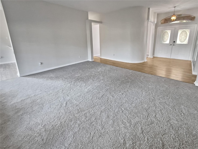 interior space with french doors and hardwood / wood-style flooring