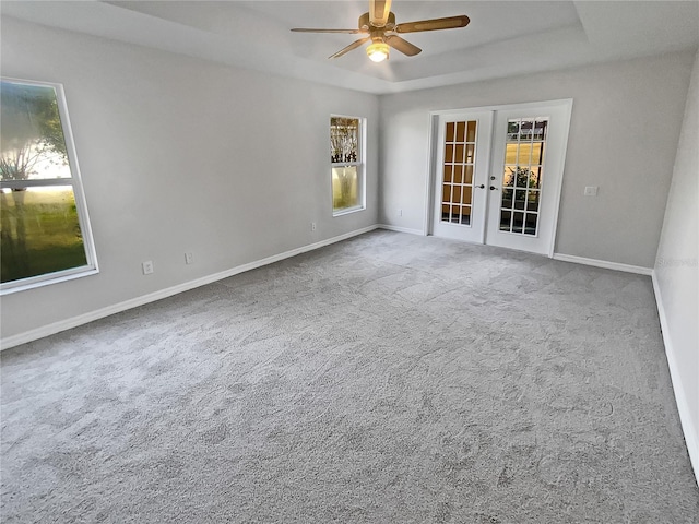 empty room with carpet flooring, french doors, and ceiling fan