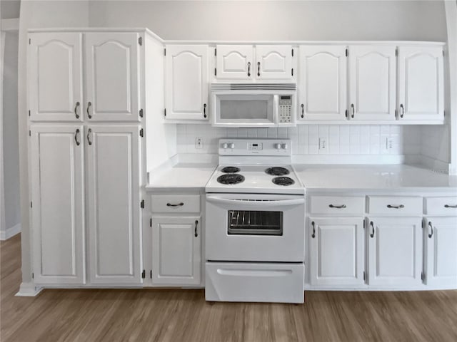 kitchen with decorative backsplash, white cabinetry, light hardwood / wood-style floors, and white appliances