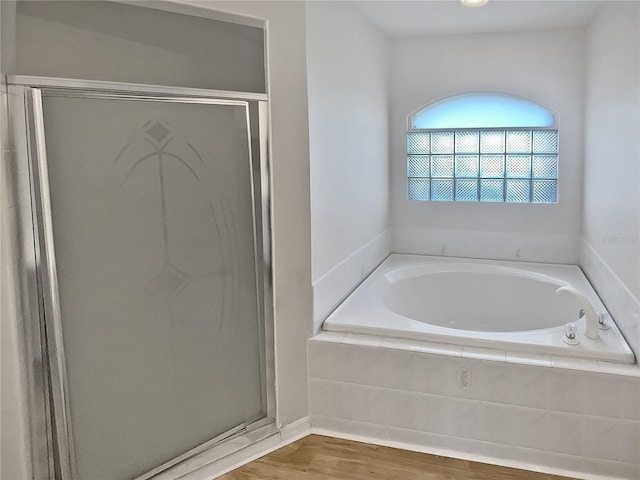 bathroom with hardwood / wood-style flooring and plus walk in shower