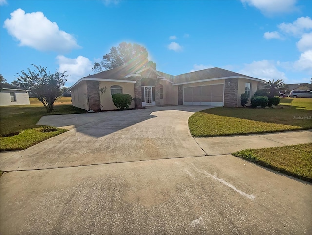 single story home featuring a front yard and a garage