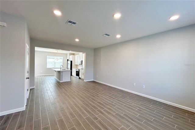 unfurnished living room featuring sink