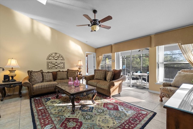 living room with ceiling fan, lofted ceiling, and light tile patterned flooring